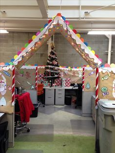 an office cubicle decorated with gingerbread and candy canes