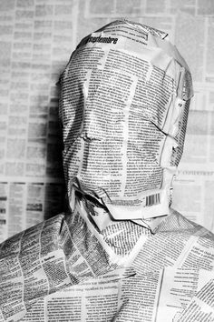 a man is wrapped up in newspaper paper