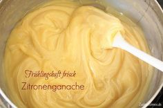 a bowl filled with yellow liquid sitting on top of a table