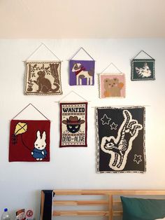 there are many wall hangings on the wall in this child's playroom