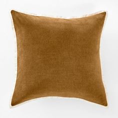 a brown pillow with white piping on the front and back side, against a white background