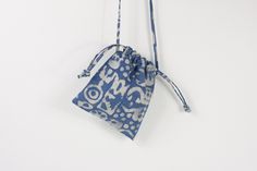 a blue and white bag hanging on a wall