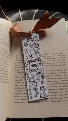 an open book with a ribbon tied around it