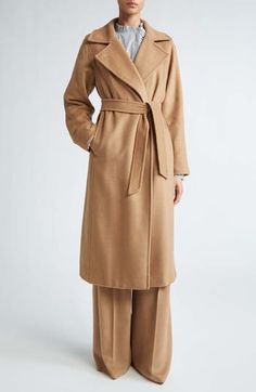 Originally designed in 1998 and now considered an icon, this camel-hair coat is an investment piece that you can buy now and wear forever. Sewn with signature tonal pickstitching, the wrap silhouette is flattering whether worn open or cinched with the tie belt. 45 1/2" length (size 6) One-button closure Notched lapels Side-seam pockets Removable tie belt Back vent Lined 100% camel hair Dry clean Made in Italy Women's Designer Clothing Max Mara Manuela Coat, Belted Wrap Coat, Max Mara Coat, Wrap Coat, Trench Coats Women, Oversized Silhouette, Mode Inspiration, Contemporary Fashion, Winter Wear