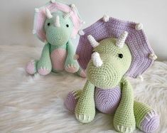 two crocheted stuffed animals sitting next to each other