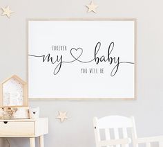 a baby's room with a white dresser and wooden stars on the wall above it