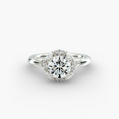 a white gold engagement ring with an oval diamond center