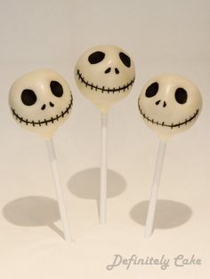 three lollipops with faces on them sitting in the shape of jack skewers