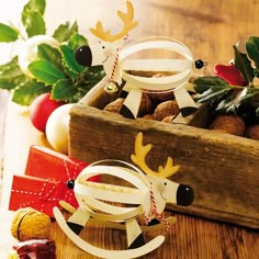 two wooden reindeer ornaments sitting on top of a table next to other christmas decoration items