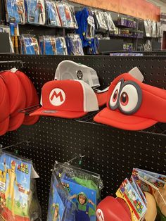 hats and other items are on display in a store aisle, with children's toys for sale behind them