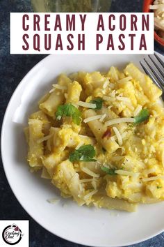 a white plate topped with scrambled eggs and parmesan cheese next to a fork