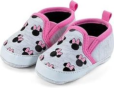 a pair of baby shoes with minnie mouses on them