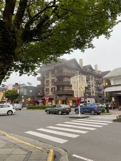 cars are parked on the street in front of buildings