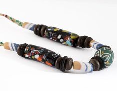 Beautifully crafted vintage handmade art glass beaded necklace featuring Ghana powder & African Venetian glass beads.A wonderful gift idea or collectible for those that adore unique African trade beads. This necklace measures 18.25 inches in total and has a barrel clasp closure.Each bead varies in size, the center bead measures .75 inches in length & the two long black beads measure 1.2 inches in length.♥ Please full-view each photo for detail / wear and ask any questions prior to purcha Artisan Glass Beads As Gift, Recycled Glass Beaded Necklaces With Round Beads As Gift, Artistic Beaded Necklaces With Large Beads As Gift, Artistic Beaded Necklace With Large Beads For Gifts, Recycled Glass Beaded Necklace With Round Beads As Gift, Handmade Beaded Necklaces With Recycled Glass As A Gift, Artisan Glass Beads For Gifts, Artisan Glass Beads For Gift, Artistic Beaded Necklace With Large Beads As Gift