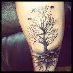 a tree with roots and birds on it is shown in this tattoo design by person