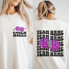 a woman wearing a t - shirt with the words team name and flowers on it