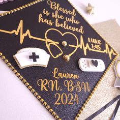 a graduation cap decorated with medical items and writing on the side, including a stethoscope