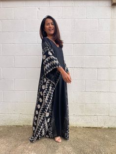 Indulge in the beauty of our classic kaftan with hand silk-screen printed fabric. This kaftan dress boasts unique patterns on high-quality rayon fabric. Its versatile design allows you to create many stylish looks, ensuring you always feel your best, whether you're at home or stepping out. Black Bohemian Maxi Length Kimono, Bohemian Black Printed Kimono, Black Printed Kimono For Festival, Black Printed V-neck Kaftan, Black Bohemian Tunic Kimono, Black Printed Kaftan For Festival, Traditional Black Printed Kaftan, Traditional Printed Patterned Kaftan, Black Printed Tunic Dress