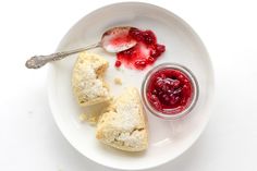 a white plate topped with pastries and jam