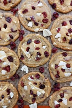 cookies with cranberries and white chocolate chips on a baking sheet, ready to be eaten