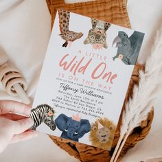 a little wild one is on the way baby shower card with zebra, giraffe, lion and elephant