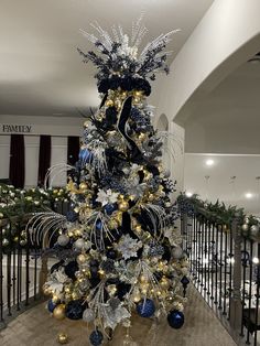 a blue and gold christmas tree in the lobby