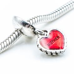 Authentic PANDORA Piece of My Heart Mother Mother Sterling Silver Dangle Charm With Red Enamel Core 790950EN27 - Retired. Generally, this charm consists of two heart dangles that are meant to be shared between a mother and a daughter. Both charms are engraved with "You and Me", "Me and You" and both enamel hearts are engraved, one with the word "mother" and the other with the word "daughter". In this case, both hearts are engraved with the word "mother." A very special gift to give to the two wo Valentine's Day Heart-shaped Dangling Charms, Red Charms For Valentine's Day, Red Charms For Valentine's Day Gift, Red Valentine's Day Gift Charms, Valentine's Day Double Heart Charms, Pandora Store, Two Hearts, Dangle Charms, Piece Of Me