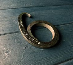 a close up of a metal object on a wooden surface