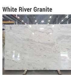 white river granite on display in a warehouse with the words white river granite above it