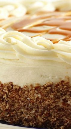 a cake with white frosting and caramel drizzle on top