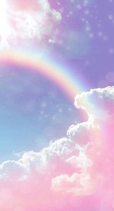 there is a rainbow in the sky with clouds