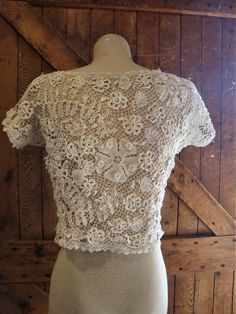 "This is an antique Irish lace blouse, from around 1910-20. The flowers are outstanding, so dimensional and different. There are no closures, goes over your head. The hem is accented with filet lace. There are a few broken threads here and there. I did not launder or press this blouse, just presenting it as found. Comes from a smoke free home. Measurements: Bust: 38\" Waist: 34\" Hip: 42\" Across Shoulder: 15.5\" Back Length: 16.5\" Please ask me any questions you may have before buying as this Lace Wedding Top With Lace Collar, Vintage Fitted White Lace Top, Vintage White Fitted Lace Top, Vintage Scalloped Lace For Wedding, Vintage Fitted Wedding Tops, Fitted Vintage Wedding Tops, Fitted Vintage Tops For Wedding, Lace Top With Lace Collar For Wedding, Victorian Fitted Scalloped Lace