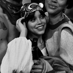 two people are posing for the camera with one person wearing a bandana on his head