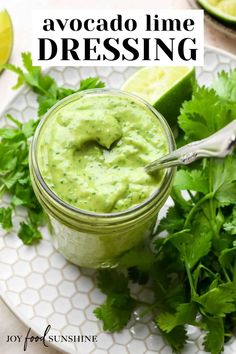 avocado lime dressing in a jar with cilantro on the side