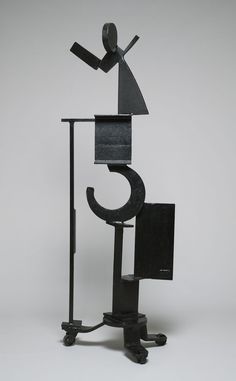 a metal sculpture with a person standing on top of it