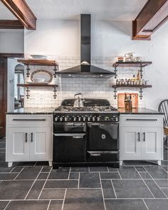 a black stove top oven sitting inside of a kitchen