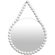 a white beaded necklace hanging from a mirror