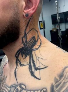 a man with a spider tattoo on his neck and behind him is an ear piercing