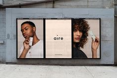 two billboards on the side of a building that say, aire and one is holding a cell phone