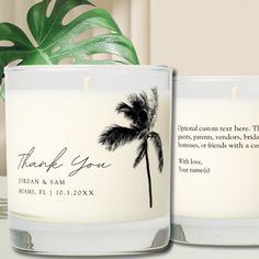 two white candles with palm trees on them and the words thank you written in black ink