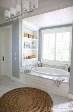 a bathroom with a large tub and white walls