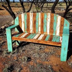 a wooden bench sitting in the middle of a field