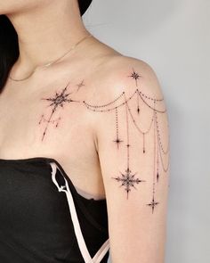 a woman with a star tattoo on her arm and shoulder, wearing a black dress