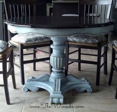 a dining room table with four chairs around it