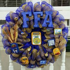 a blue wreath with letters and other items on it that spell out fafsa