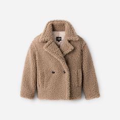 The evolution of our classic Gertrude, this double-breasted, high-texture coat is made from cozy (it'll keep you warm) material and it is designed to hit perfectly so you can catch all of your angles this season. | Hip-length double breasted teddy coat. Shell - 100% Polyester. Lining - 100% Polyester. The UGG® Logo faux horn buttons. Soft fleece  inchhand warmer inch pocket lining. 27 inch HPS Length [Size S]. 30 inch HPS Length [Size 2X]. Dry clean only. Imported. | UGG® Women's Gertrude Short Teddy Coat Faux Fur in Putty, Size XL Short Teddy Coat, Ugg Jacket, Textured Coat, Wishlist 2024, Short Loungewear, Teddy Coat, Flip Flop Shoes, Baby Boy Shoes, Classic Boots