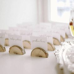 there are place cards on the table with wine