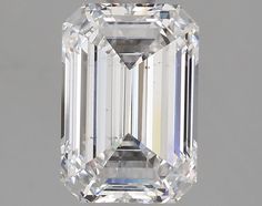 an emerald cut diamond on a white background with the center stone in between two smaller diamonds