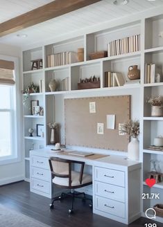 a home office with white bookcases and shelves