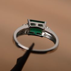 It is a lab emerald ring. The main stone is 6mm*8mm emerald cut, weight about 1.50 carats. The basic metal is sterling silver and plated with rhodium. To change the metal to a solid gold (white/rose) or platinum is also available, please ask for a quotation if you want. You can also go to my shop Home for more elegant rings: https://www.etsy.com/shop/godjewelry?ref=hdr_shop_menu More emerald rings: https://www.etsy.com/shop/godjewelry?ref=seller-platform-mcnav§ion_id=20709240 Customization is al Elegant Rings, May Birthstone Rings, Green Gemstone Ring, Ring Emerald Cut, Emerald Rings, Man Made Diamonds, Ring Emerald, Royal Jewels, May Birthstone